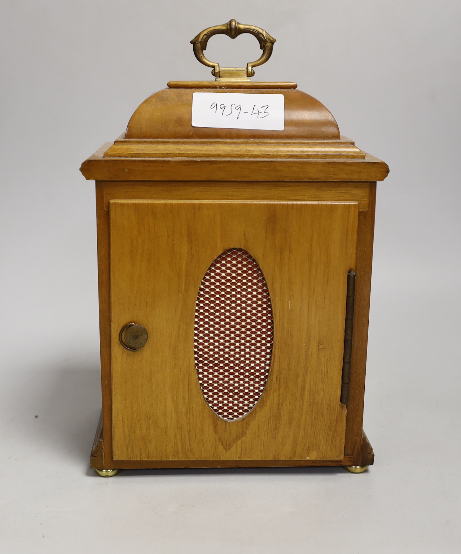 A figured walnut mantel clock by Elliott